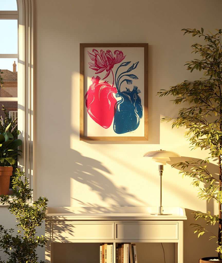 Red and blue anatomical heart linocut print with blooming flower and botanical details by Belgian artist Leda Vaes, handmade contemporary wall art in A3 format.