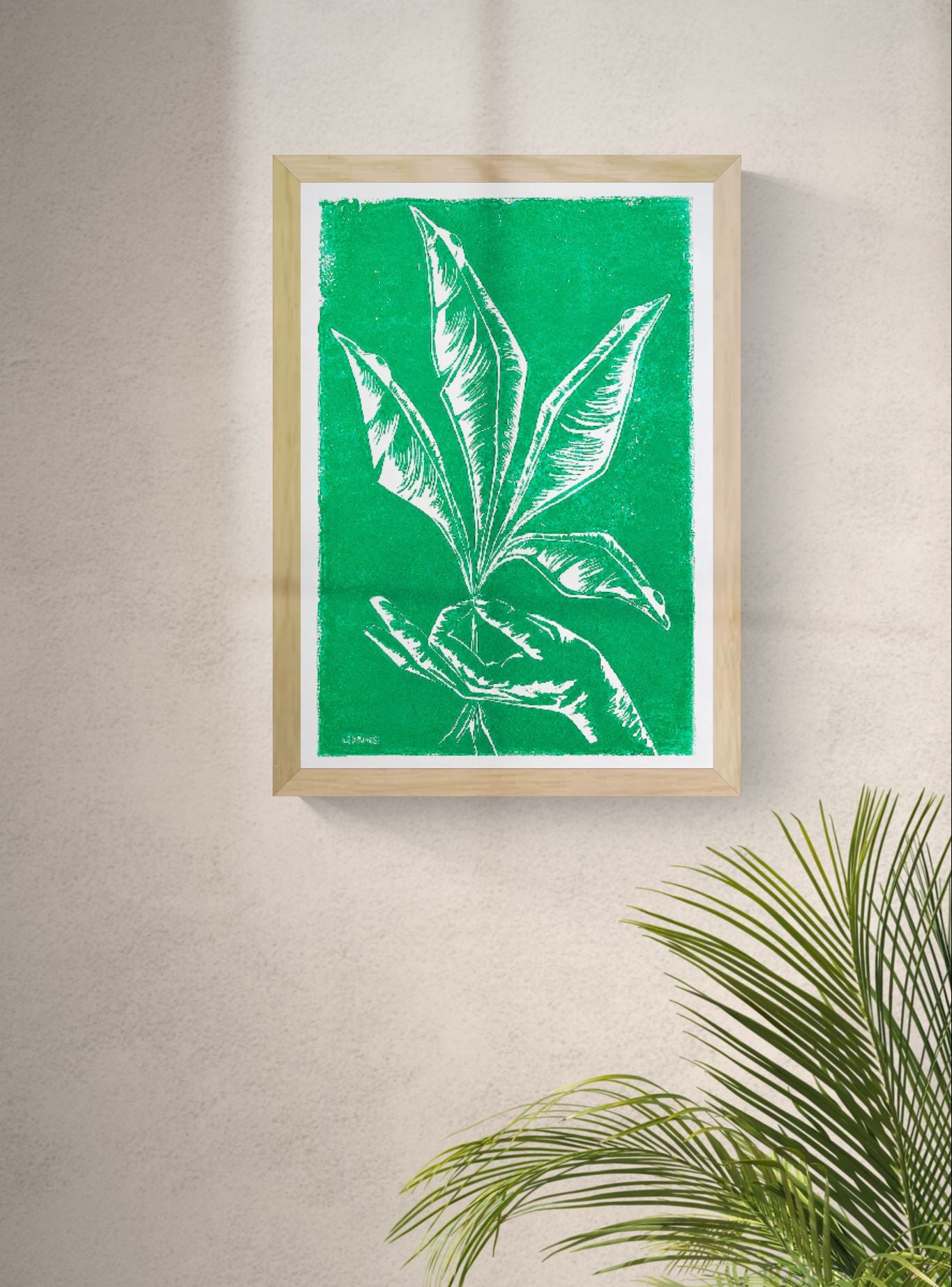 Handmade green botanical linocut print titled Vers by Belgian artist Leda Vaes featuring abstract tropical leaves and a hand in bold carved lines on textured paper, contemporary nature-inspired wall art in A3 format.