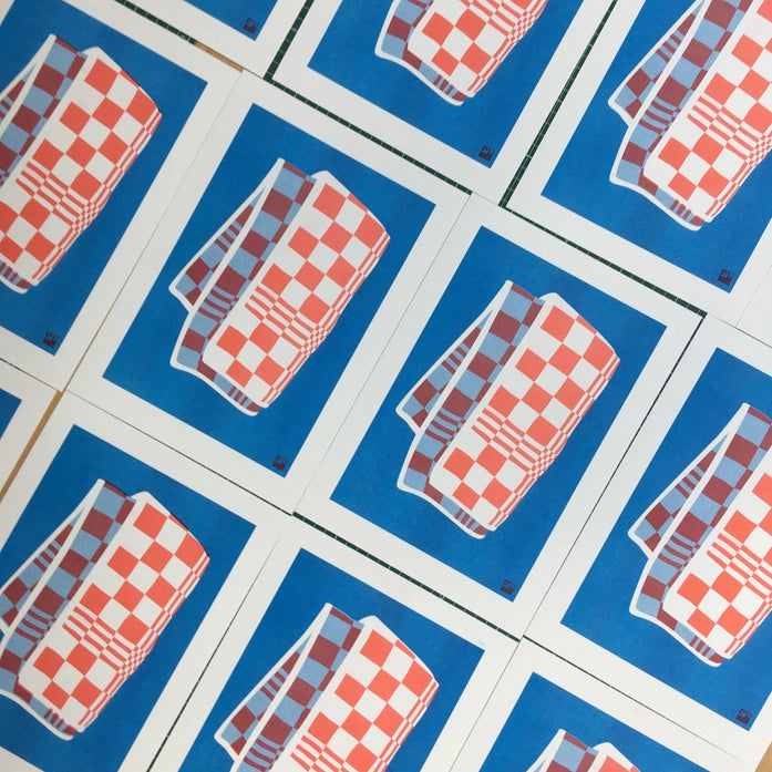 A4 risograph print titled Towel by Dutch studio VrijFormaat. Features a red and blue checkered dish towel illustrated in bold, minimalist style. Part of the “Extra Ordinary” series, printed on 160g Biotop paper using soy-based risography ink. Ideal for lovers of design, pattern, and printmaking.