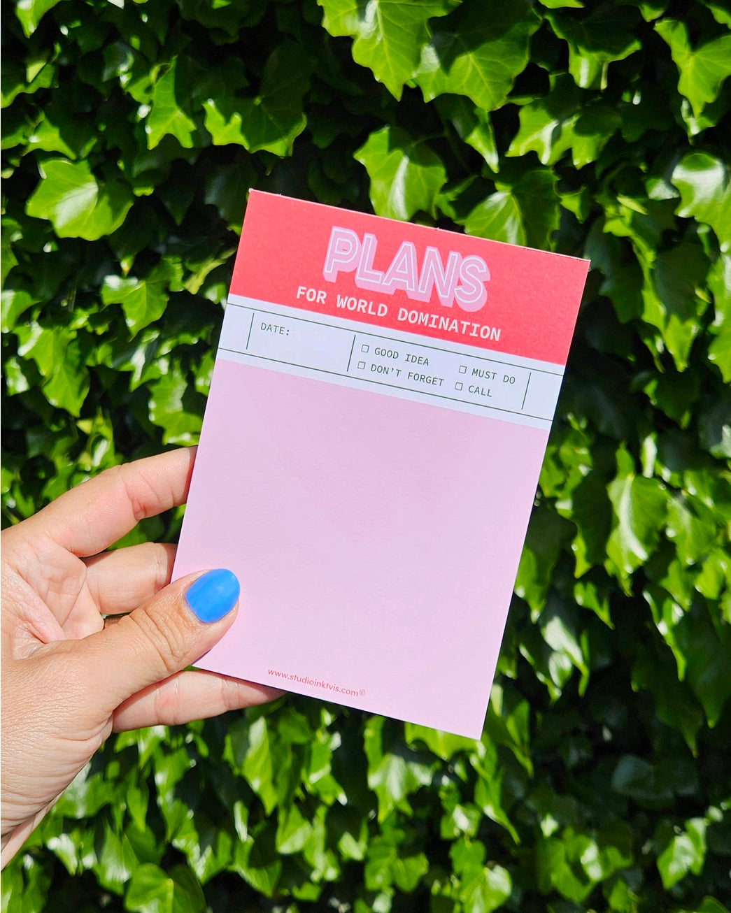 Funny red and pink notepad titled “Plans for World Domination” by Studio Inktvis, A6 size with 50 blank pages for notes, tasks, or outrageous goals, printed in the Netherlands.