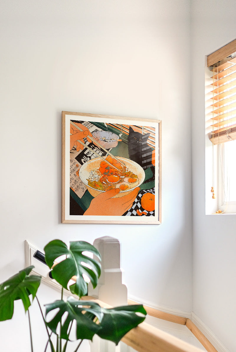 Midnight Noodles by Enikő Eged, 50 x 50 cm archival giclée art print featuring a cozy noodle bowl scene with a black cat, warm orange tones, and Japanese-inspired details.