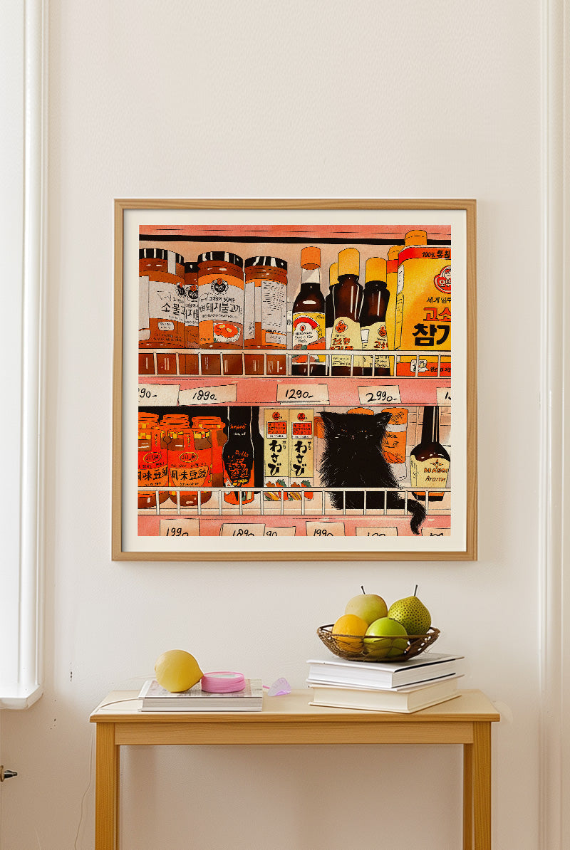 Archival giclée art print by Enikő Eged showing a black cat looking at Japanese grocery shelves filled with colorful sauces, jars, and food packaging.