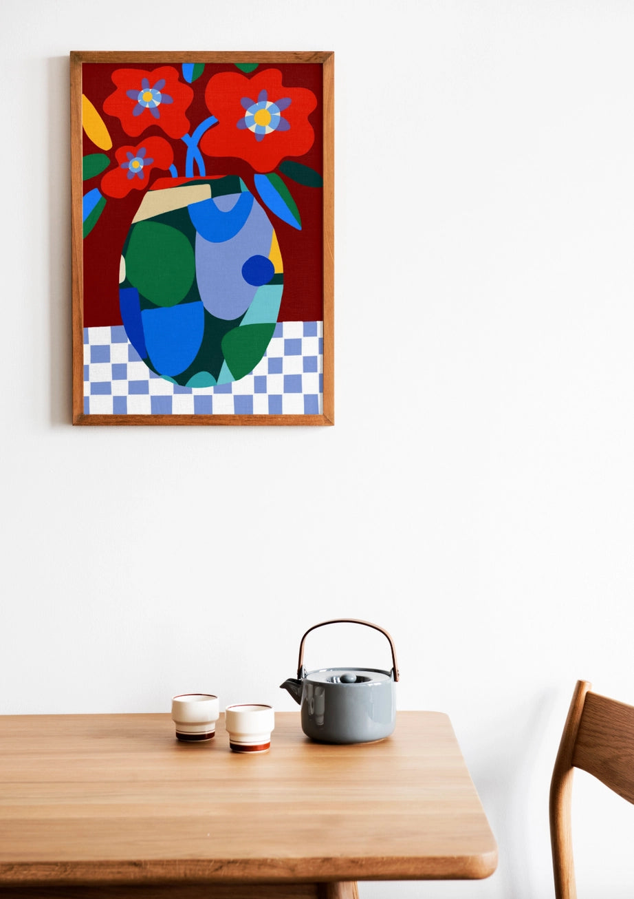 Burgundy on Check by Teresa Rego – colorful abstract floral art print with red flowers in a geometric vase on a checkered tablecloth, bold contemporary design perfect for modern home decor, available at Galerie Frits