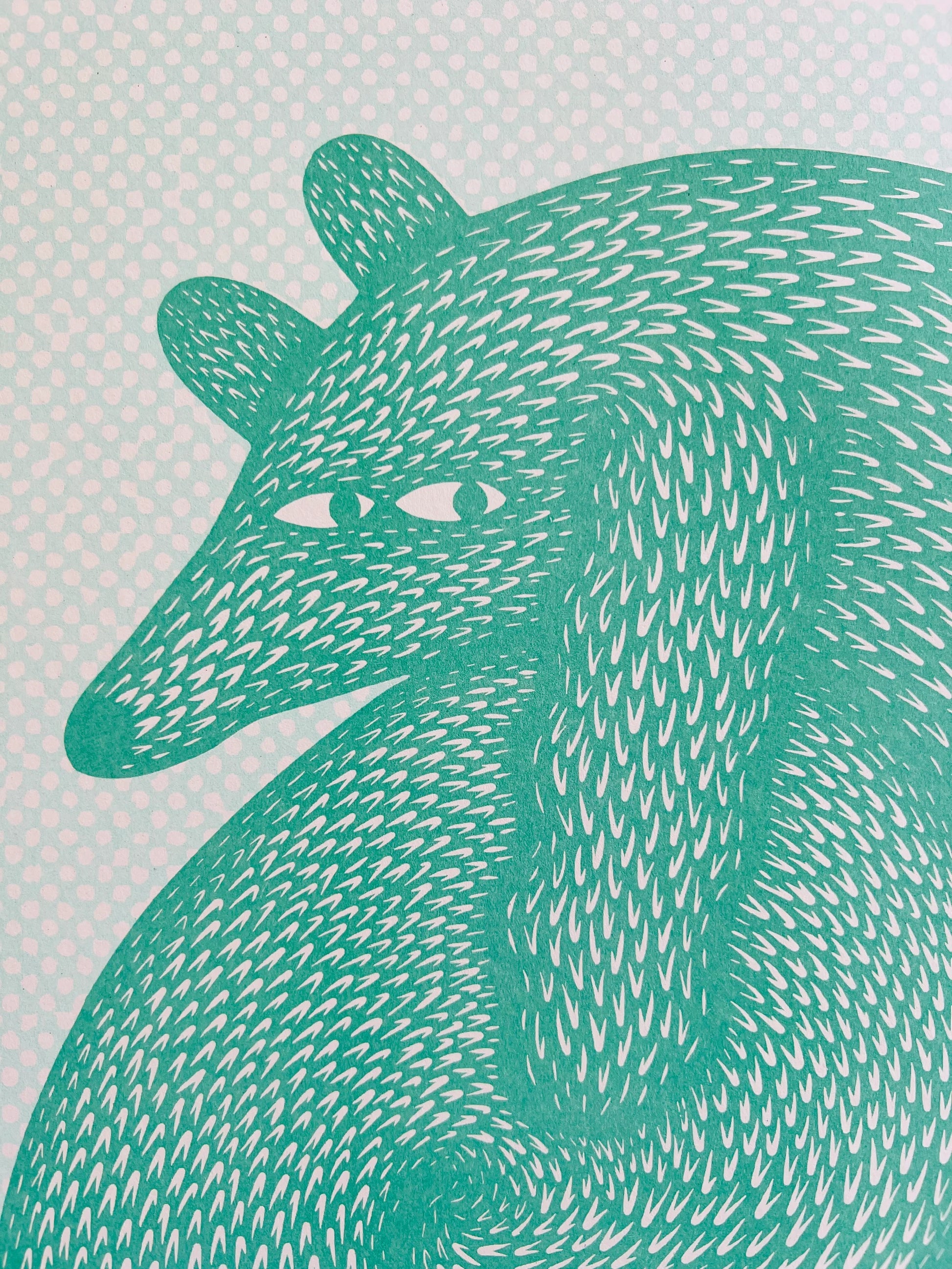 Playful risograph illustration of a curled-up green animal resembling a fox or dog, with hypnotic, swirling fur patterns and expressive eyes, titled Sausage Roll by Strangford, printed on A3 recycled paper in Northern Ireland.