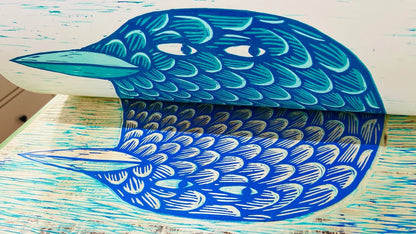 Limited edition 50 x 70 cm woodcut titled Waddle I Do by Northern Irish artist Strangford. Features a whimsical blue bird with expressive eyes and intricate feather textures, hand-printed using oil-based ink on 300g paper. Edition of 90, handcrafted in Northern Ireland.