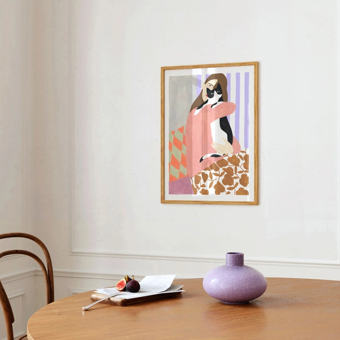 Art print 'Cat and Woman' by Depeapa – modern illustration of a woman lovingly embracing a black and white cat. Contemporary artwork with bold colors, patterned textiles, and minimalist forms. A cozy and emotional composition perfect for cat lovers and modern art collectors, available at Galerie Frits