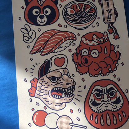 Nihon art print by Yeaaah! Studio featuring colorful Japanese pop culture icons including sushi, ramen, Daruma doll, octopus mascot, Godzilla-style fish, and red panda, in orange, blue, and cream tones. Printed on 300g Old Mill Premium White paper, 30x40 cm, digital print, made in France, unframed.