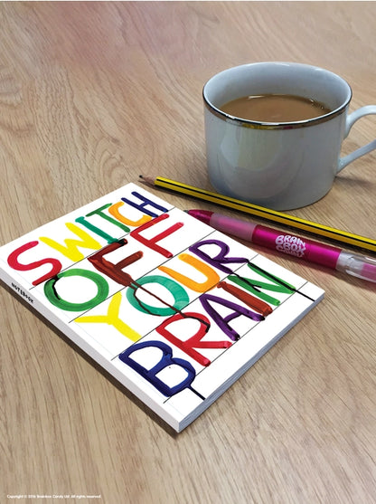 A6 notebook with colorful text saying “Switch Off Your Brain” by David Shrigley – vibrant and humorous design printed on sustainable paper, perfect for creatives and stationery lovers.