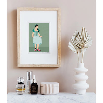"Feet on the Ground" by Doriane Millet – minimalist illustration of a modern girl in a fairytale-style dress and red sneakers, standing confidently on a muted green background; whimsical and empowering wall art print blending classic and contemporary styles, available at Galerie Frits