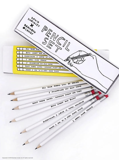 David Shrigley pencil set with 7 silver HB pencils in a yellow gift box, each featuring a humorous phrase by the British artist—ideal creative gift made in the UK for fans of quirky art and stationery.