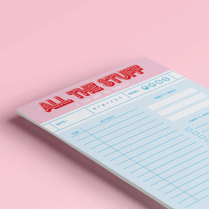 Funny and colorful A5 notepad with bold red and pink lettering, including to-do lists, goals, mood tracker and humorous sections like "Today’s Shit List" – designed by Dutch brand Studio Inktvis and printed in the Netherlands.