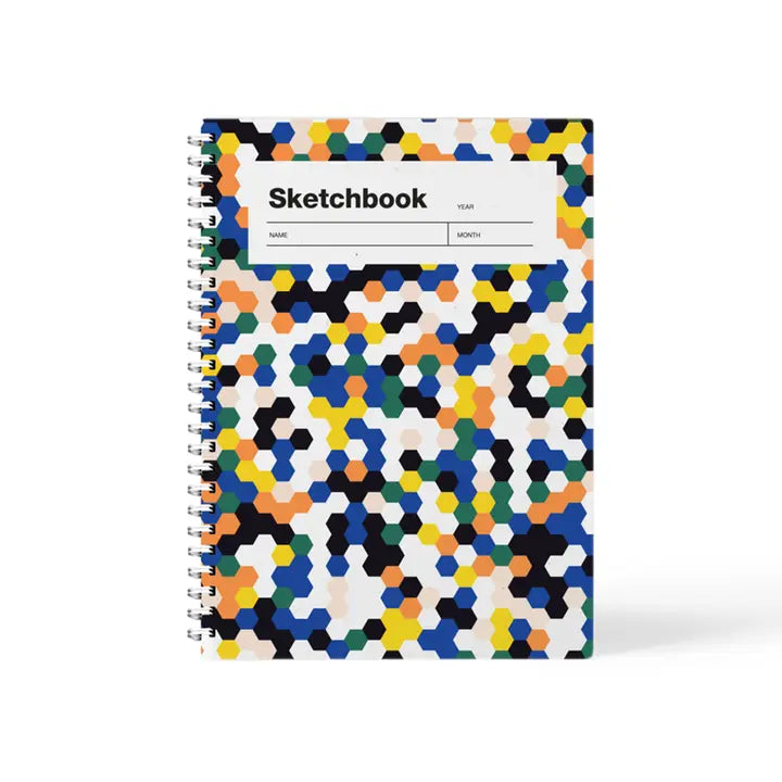 Colorful mosaic A5 sketchbook by Weew Smart Design, featuring a vibrant hexagonal pattern cover and white spiral binding, with 100 blank pages on smooth 80gsm paper – perfect for daily sketching or creative