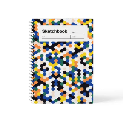 Colorful mosaic A5 sketchbook by Weew Smart Design, featuring a vibrant hexagonal pattern cover and white spiral binding, with 100 blank pages on smooth 80gsm paper – perfect for daily sketching or creative
