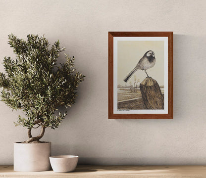 Vintage vertical digital art print of a wagtail perched on a wooden post above a quiet rural landscape, illustrated in warm cream, brown and black tones, ideal as nature-inspired wall art.