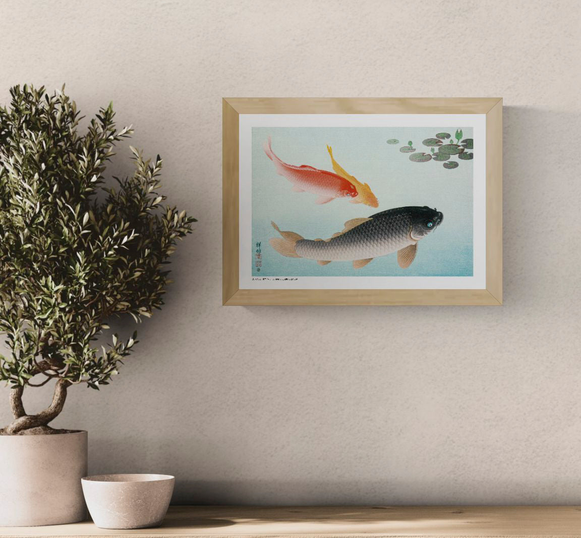Horizontal Japanese art print by Ohara Koson showing red, golden and black carp swimming through pale blue water beneath dark green lily pads, ideal for calm living room or bedroom wall decor.