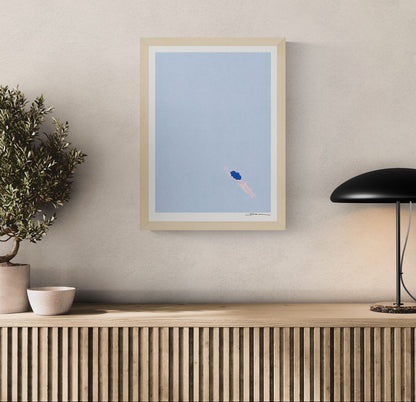 Minimalist risograph art print of a lone swimmer floating in a pale blue sea by Studio Stoutpoep. Soft pastel colors, portrait orientation, calming contemporary wall art for modern interiors.