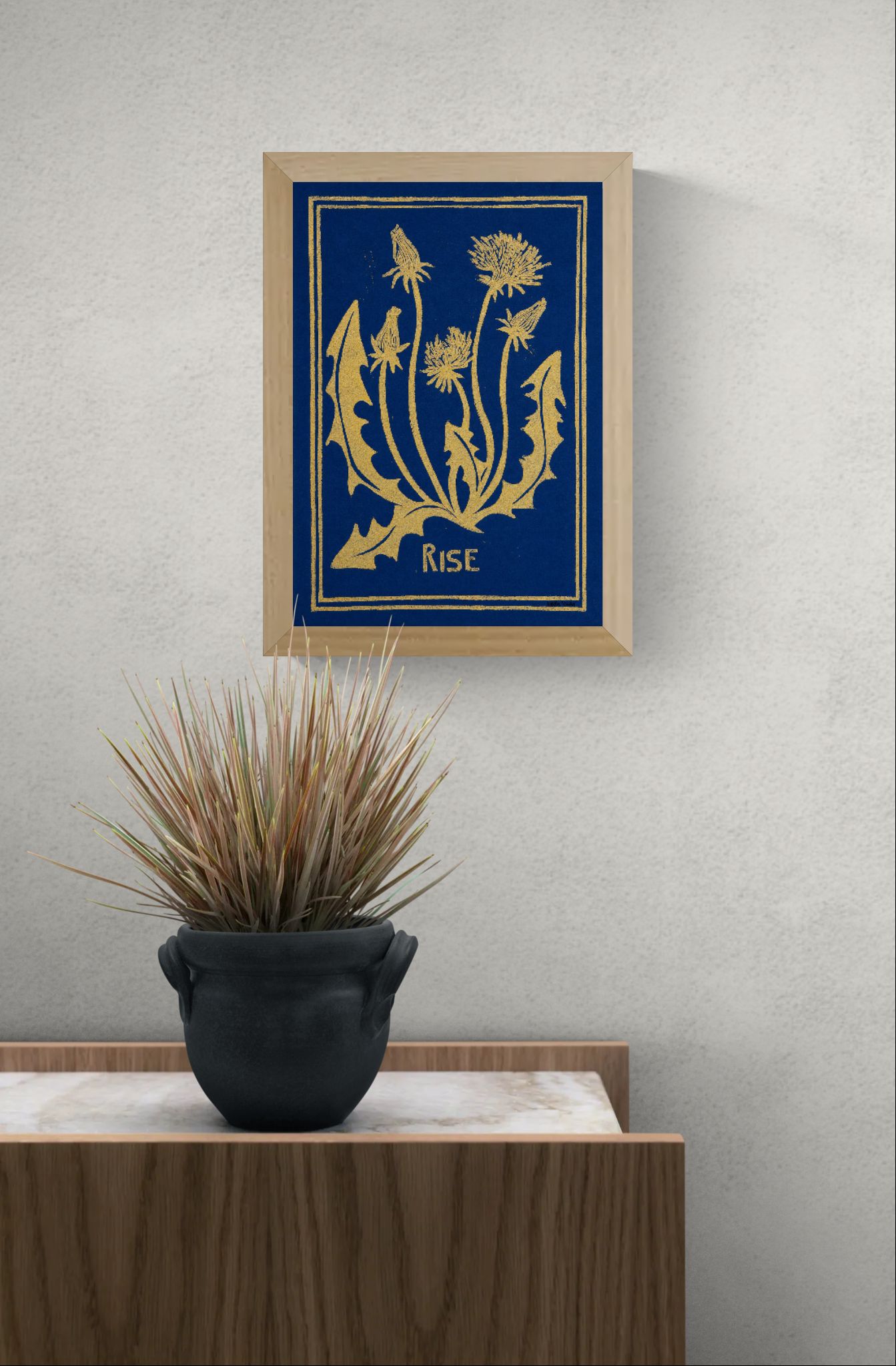 Blue and yellow handmade linocut print titled Rise by Belgian artist Leda Vaes featuring abstract dandelion flowers and organic botanical shapes on textured paper in A4 format.