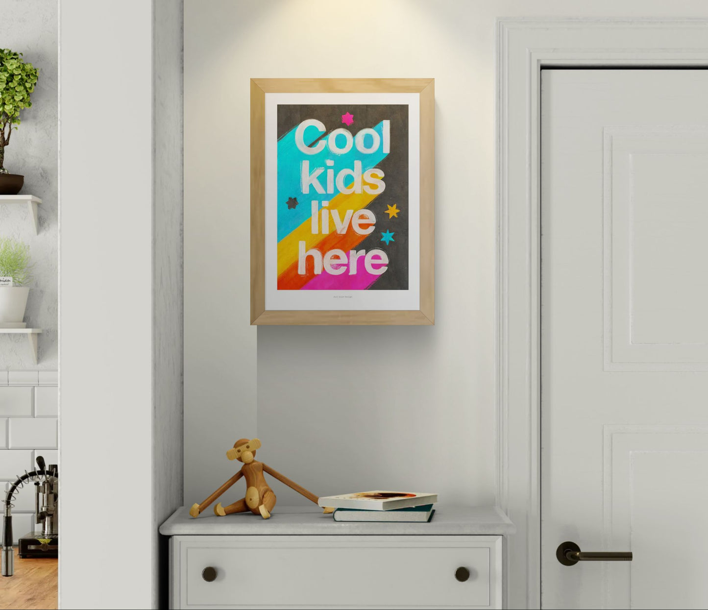 Giclée art print by Just Cool Design with the phrase "Cool kids live here" in bold white letters over a bright rainbow background with stars, ideal for colorful children's rooms or playful modern decor.
