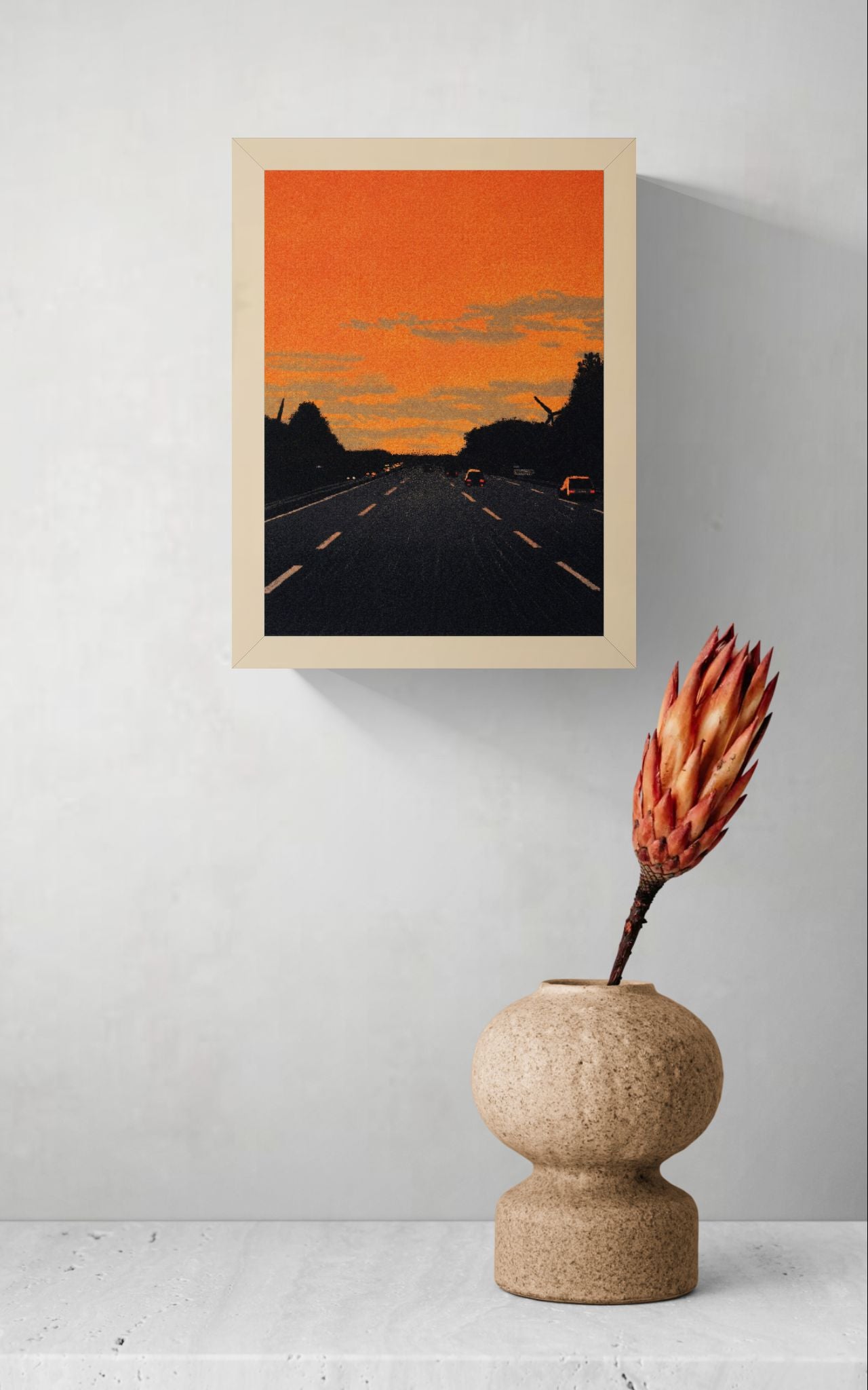 Vertical giclée art print showing cars driving along a dark motorway beneath a vivid orange sunset, with textured clouds and black tree silhouettes, ideal for modern hallway, office or gallery wall decor.