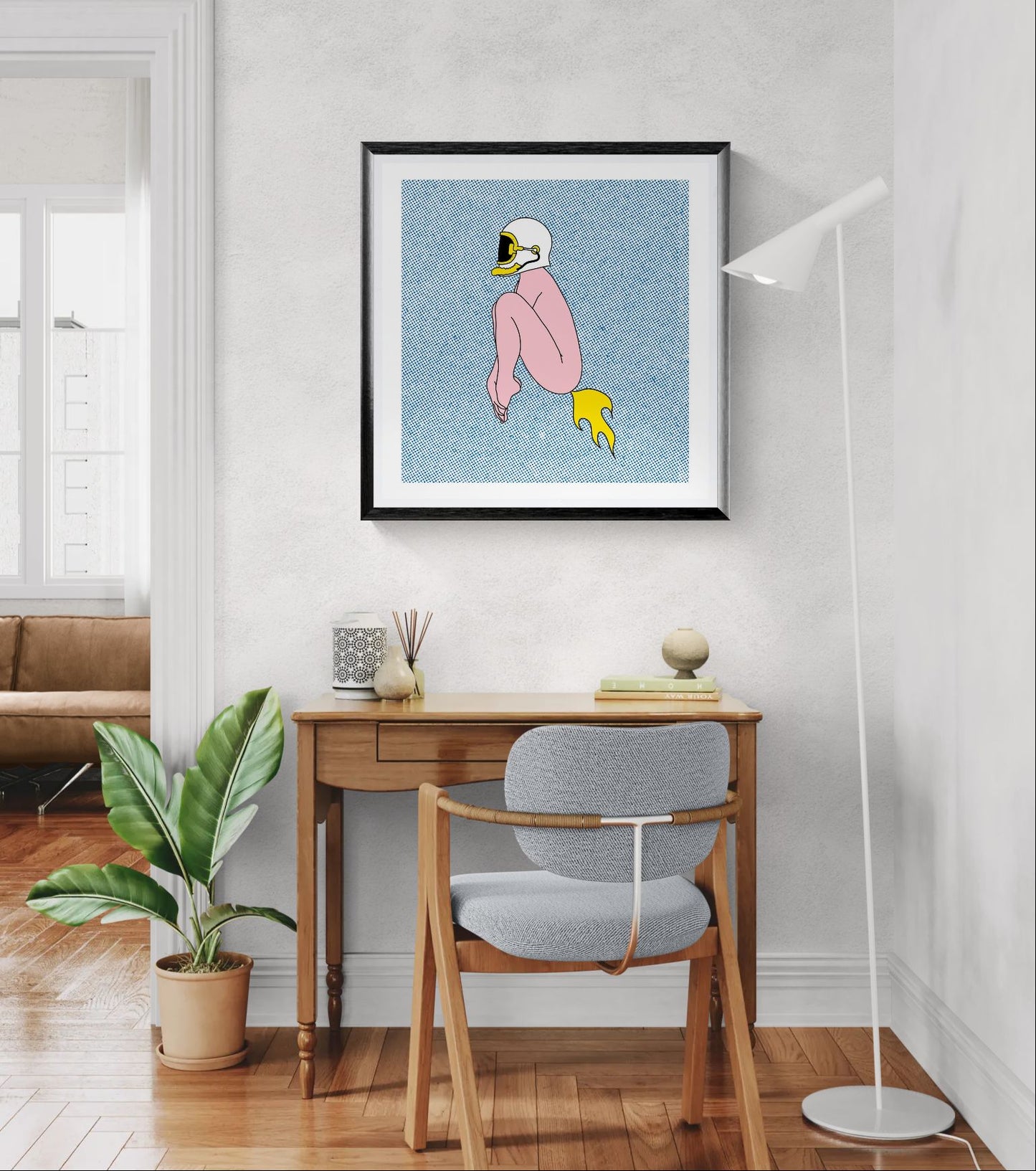 Surreal digital art print featuring a seated pink figure wearing a motorcycle helmet with a yellow rocket flame, set against a blue halftone background. Minimalist contemporary illustration with bold colors, square format wall art for modern interiors.