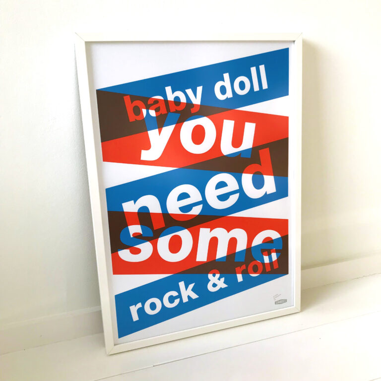 Three-color screen print ‘BABYDOLL’ by Dutch duo Gumbootz, featuring bold overlapping red, blue and grey text saying ‘baby doll you need some rock & roll,’ arranged in dynamic angled blocks on a 50×70 cm art poster; modern graphic typography artwork perfect for contemporary interiors.