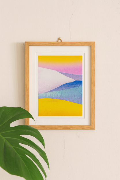 Minimal pastel landscape risograph print by Dutch illustrator PTRVRKD featuring yellow sand dunes, blue hills, and a soft pink sky gradient. Handmade 12.5 x 17.5 cm art print on Biotop 250 gsm paper with soy-based inks. Ideal wall art for modern interiors, Scandinavian style, or desert-inspired home décor.