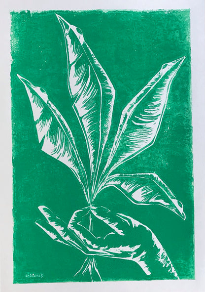 Handmade green linocut by Belgian artist Leda Vaes showing a hand gently holding tall, elongated plant leaves, carved in crisp white lines with a natural, minimalist, botanical aesthetic; nature-inspired art print for modern home décor.