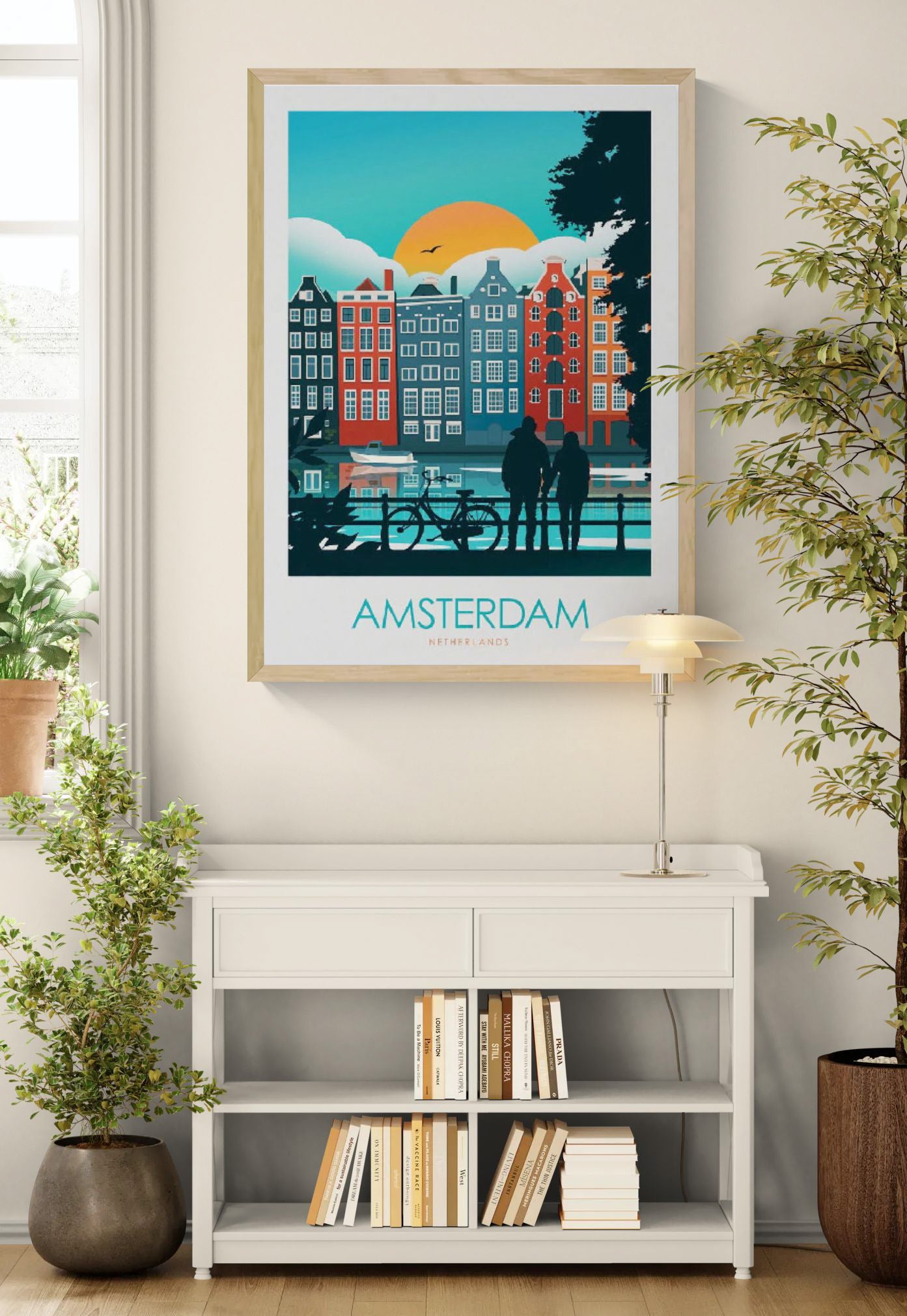 Colorful Amsterdam travel poster by Studio Inception featuring canal houses at sunset, a couple by the water, and a bicycle silhouette. Modern wall art print evoking Dutch architecture, romance, and vibrant city life.
