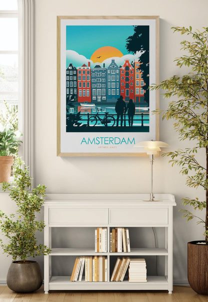 Colorful Amsterdam travel poster by Studio Inception featuring canal houses at sunset, a couple by the water, and a bicycle silhouette. Modern wall art print evoking Dutch architecture, romance, and vibrant city life.