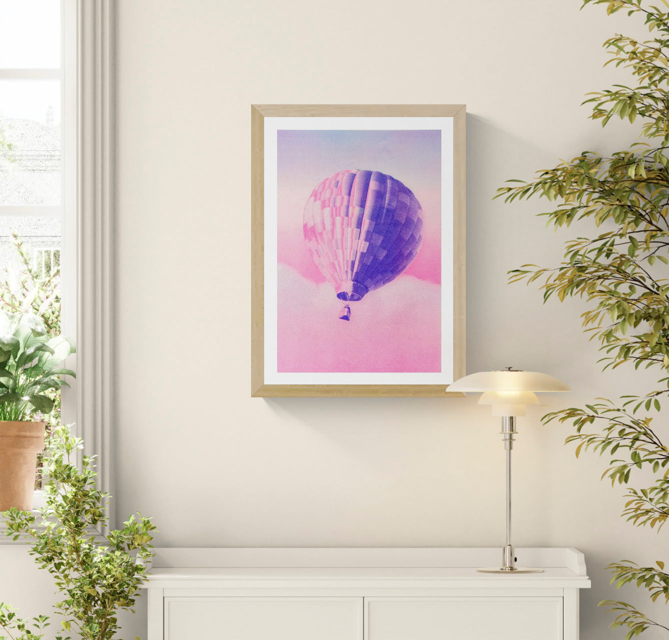 A3 risograph print of a pink and blue hot air balloon floating over dreamy clouds by PTRVRKD, hand-printed on 300 gsm Biotop paper.