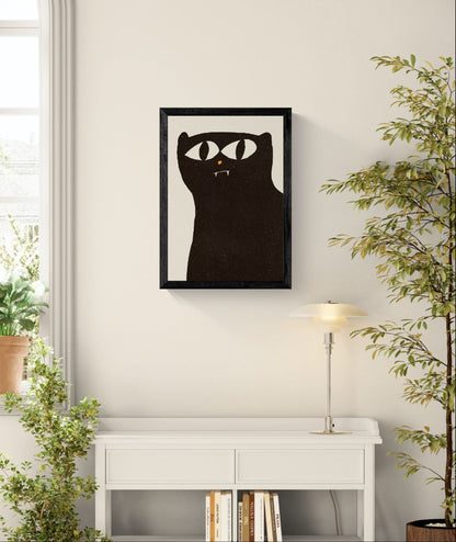 Minimalist black cat art print by Enikő Eged, featuring a bold black cat with large white eyes, tiny fangs and an orange nose on a soft cream background.