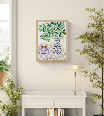 Greek Patio by Leens, colorful Mediterranean-inspired digital art print featuring olive branches in a decorative blue ceramic vase beside a pink coffee cup on a lilac checkered tablecloth, botanical wall art for cozy kitchens and modern interiors.