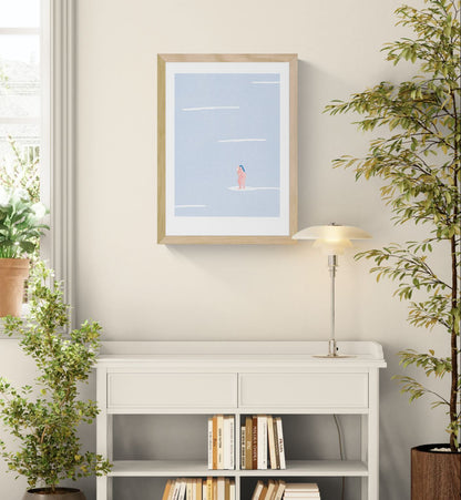 Minimalist risograph art print featuring two nude female figures standing together on a white surf-like shape in a pale blue textured landscape, soft pink and blue tones, portrait orientation, contemporary wall art for modern interiors.
