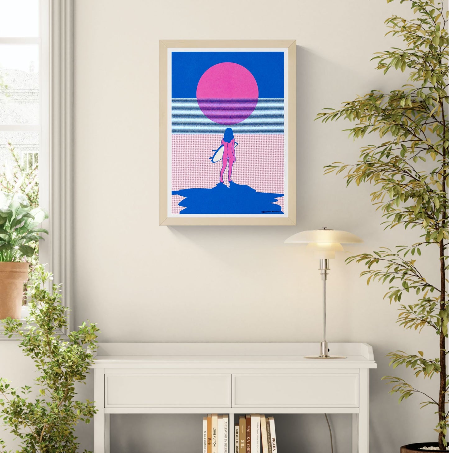 Minimalist risograph print of a surfer standing on the beach facing a bright pink sun over the sea, in bold blue and pink tones. Contemporary landscape wall art for modern coastal interiors.