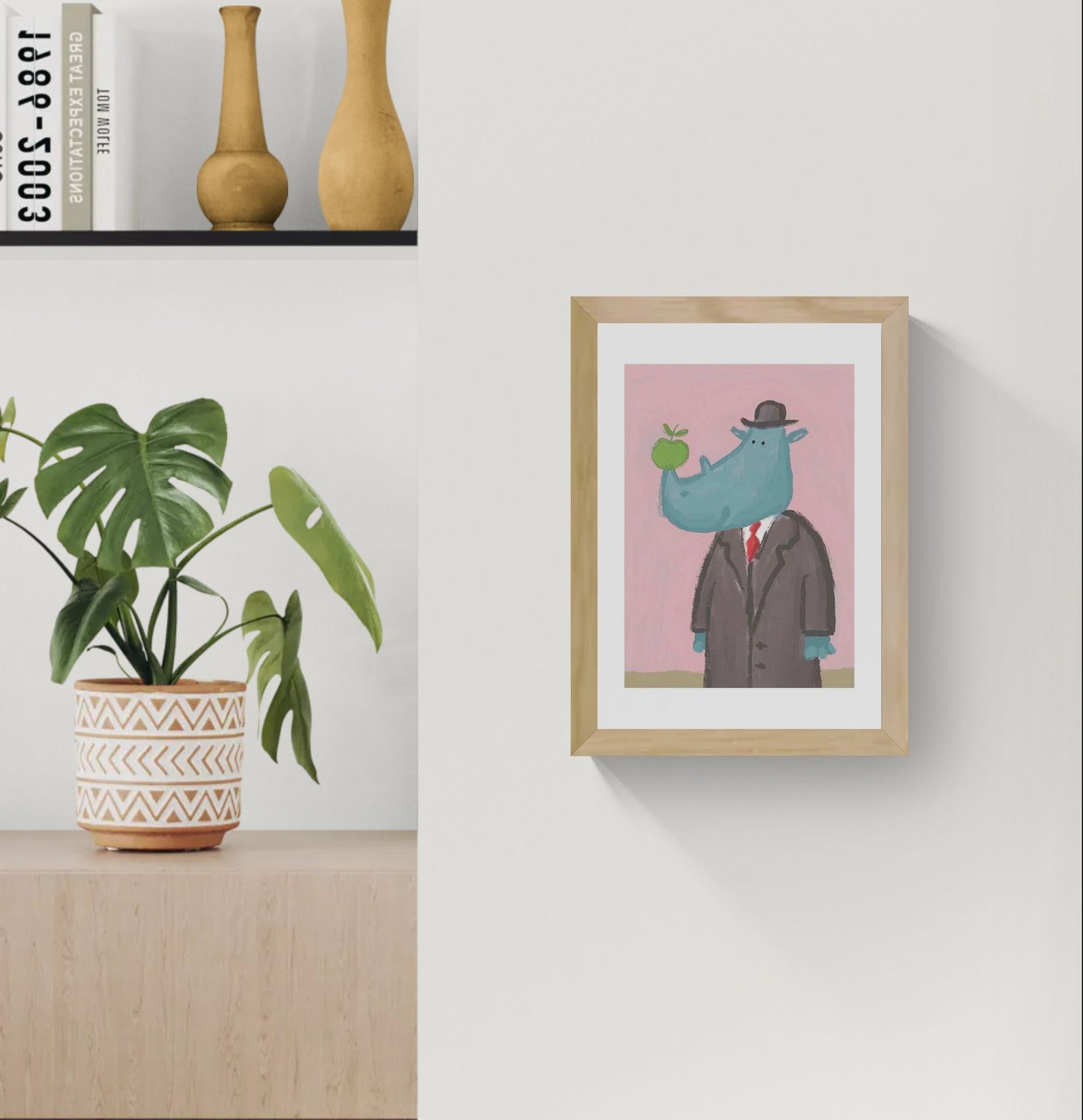 Surreal rhino illustration by Willy Leung featuring a blue rhinoceros in a formal suit and hat holding a green apple against a soft pink background, printed as an A4 archival giclée art print.