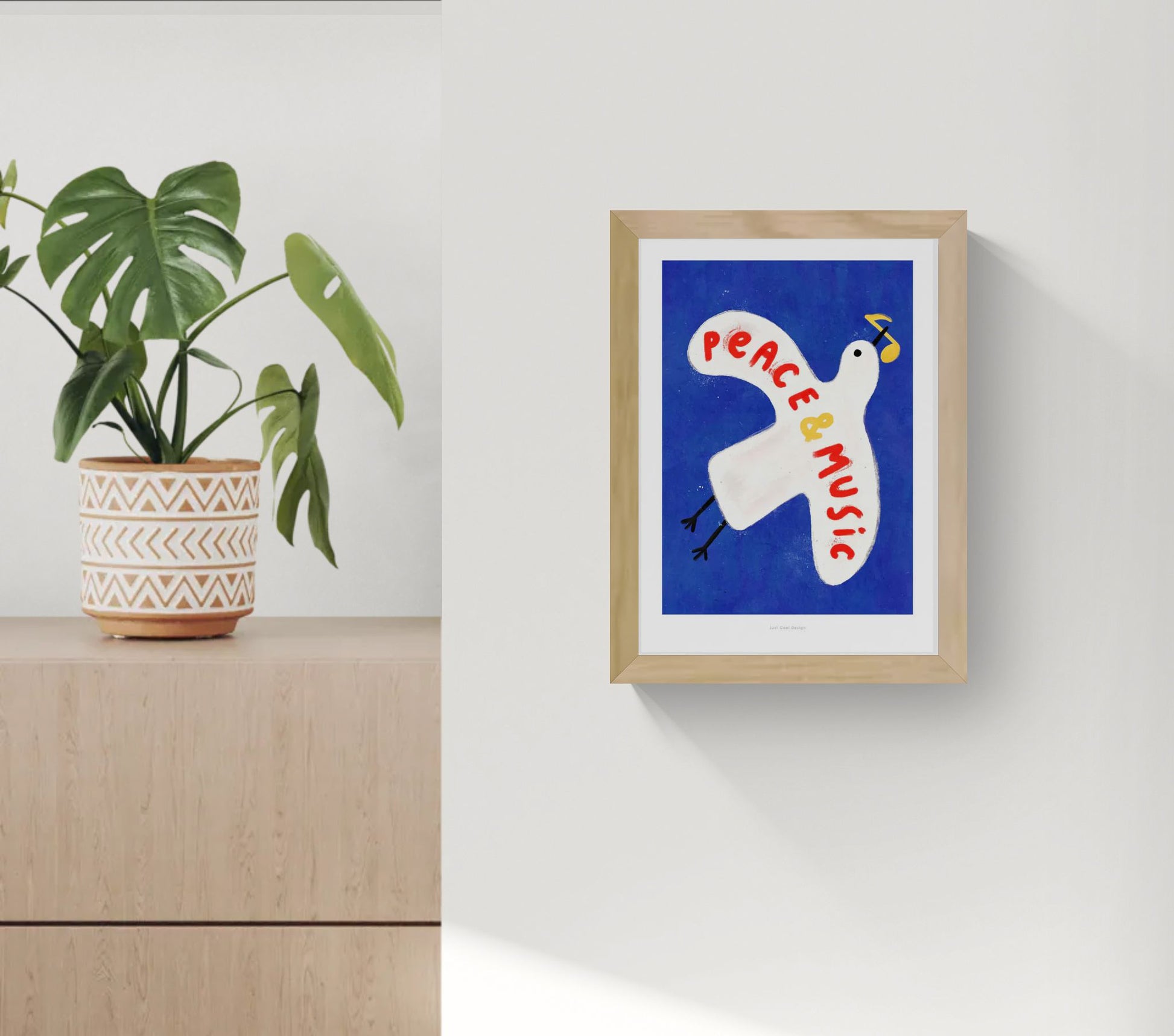 Colorful art print of a white pigeon carrying a yellow musical note on a deep blue background with the hand-painted phrase “Peace & Music” in red and yellow letters. Whimsical and modern illustration by Just Cool Design, perfect wall art for music lovers and optimistic interiors.