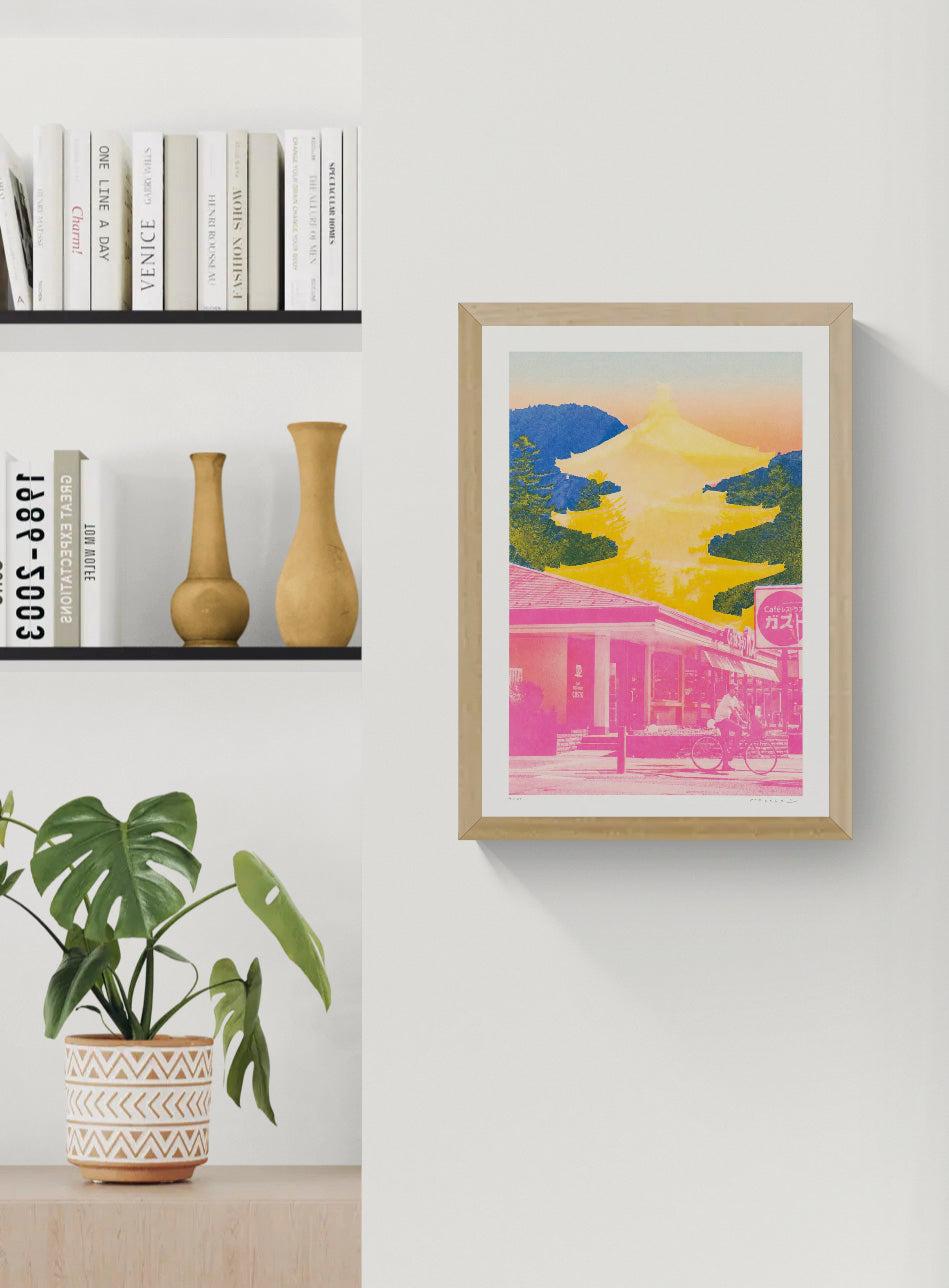 Bold Japan-inspired art print with pink urban street scene, cyclist, yellow Fuji pagoda silhouette and deep blue mountain background – Fuji Landscape Collage 2 by Dutch artist PTRVRKD, A3 risograph print, limited edition.