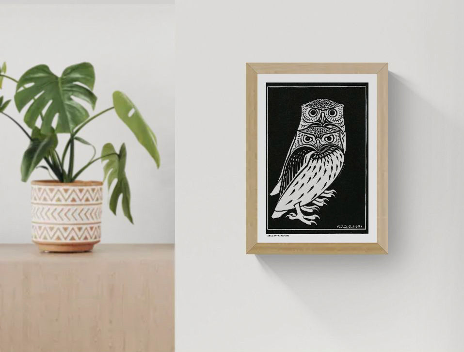 Vertical black-and-white digital art print of two stylised owls by Julie de Graag, based on a 1921 woodcut, with bold graphic lines for study, hallway, or living room wall decor.