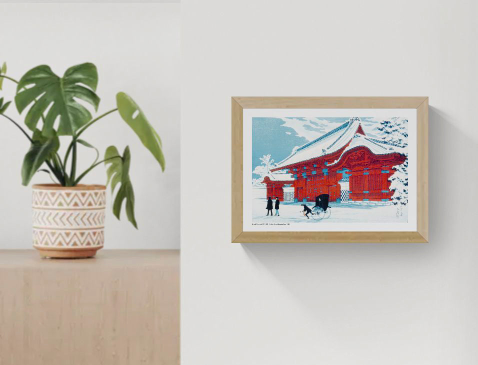 Horizontal Japanese winter scene showing a vivid red gate in Hongo covered with snow, a rickshaw and pedestrians, rendered in blue, white and red as decorative wall art.