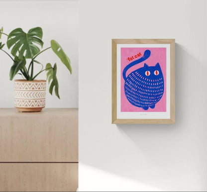 "Fat Cat" by Just Cool Design – playful and bold illustration of a chubby blue cat with red eyes on a vibrant pink background, featuring the text “fat cat”; a fun and colorful wall art print perfect for cat lovers and modern pop art enthusiasts, available at Galerie Frits