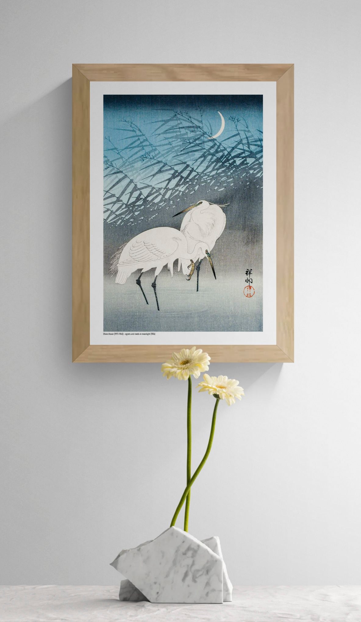 Two white egrets standing among layered reeds beneath a crescent moon, illustrated in a vintage Japanese woodblock style with blue and grey tones, vertical A4 digital print for calm wall decor.