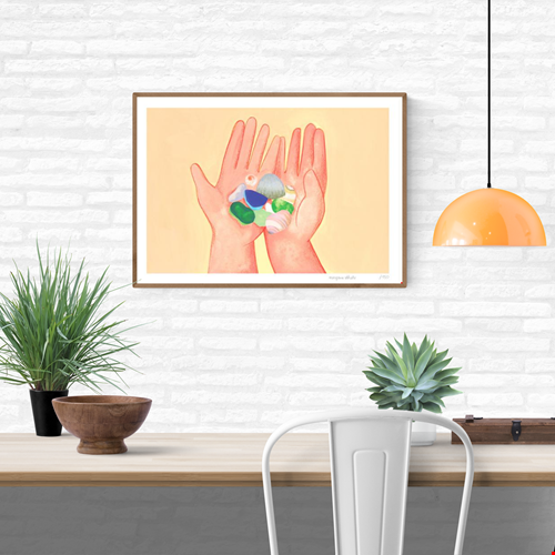 Coquillages by French illustrator Margaux Othats, A3 (29.7 x 42 cm) risograph print in delicate pastel colors. The artwork shows two hands holding seashells and sea glass, evoking summer memories and tenderness. Printed on 150g Munken Print White paper, limited edition of 150 signed and numbered copies, made in Belgium, unframed, packaged with protective sleeve and cardboard backing.