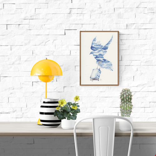 In Transit art card by Belgian artist FAB, A6 size (10.5 x 14.8 cm) printed on 300g Munken Pure Rough paper, featuring a blue watercolor bird in flight carrying a rolling suitcase, symbolizing travel and freedom.