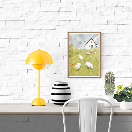 A soft watercolor-style illustration showing a white farmhouse on a green hill under a cloudy sky, with several fluffy sheep grazing among wildflowers. A serene and poetic countryside art print by Stien van Kerckhoven, perfect for cozy interiors and Scandinavian-inspired decor.