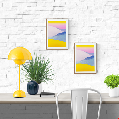 Minimal pastel landscape risograph print by Dutch illustrator PTRVRKD featuring yellow sand dunes, blue hills, and a soft pink sky gradient. Handmade 12.5 x 17.5 cm art print on Biotop 250 gsm paper with soy-based inks. Ideal wall art for modern interiors, Scandinavian style, or desert-inspired home décor.