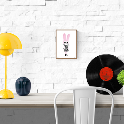 Playful handprinted screenprint of a pink rabbit with a black dress and boots, whimsical and minimal illustration by Plumo – A5 art print made in Belgium.