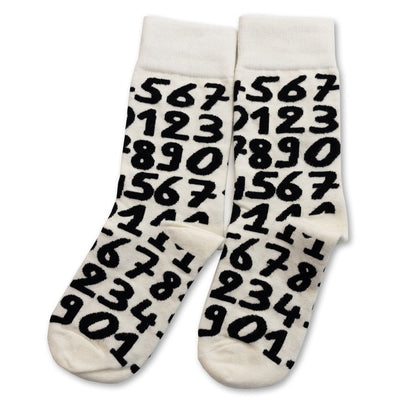 White crew socks with bold black numbers by Sarah Corynen – unisex cotton socks in size 38-42, playful illustrated design for math lovers and quirky everyday style.