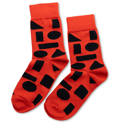 Red crew socks with bold black abstract shapes by Sarah Corynen – size 38-42 unisex cotton blend, playful geometric design for creative and colorful style.
