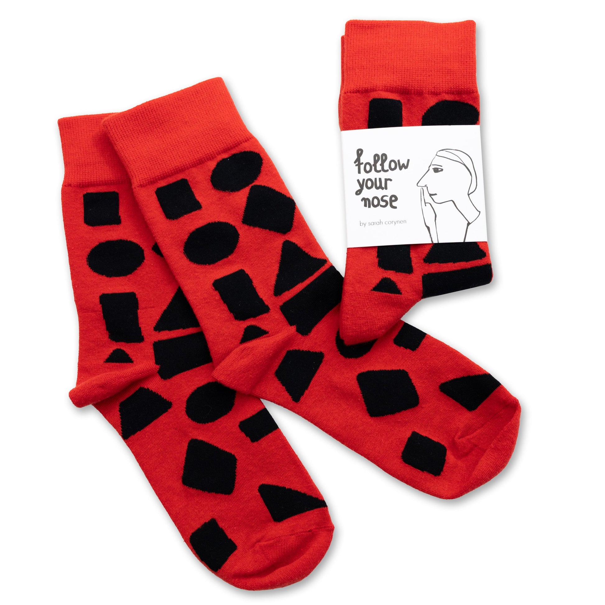 Red crew socks with bold black abstract shapes by Sarah Corynen – size 38-42 unisex cotton blend, playful geometric design for creative and colorful style.