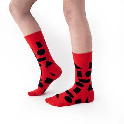 Red crew socks with bold black abstract shapes by Sarah Corynen – size 38-42 unisex cotton blend, playful geometric design for creative and colorful style.